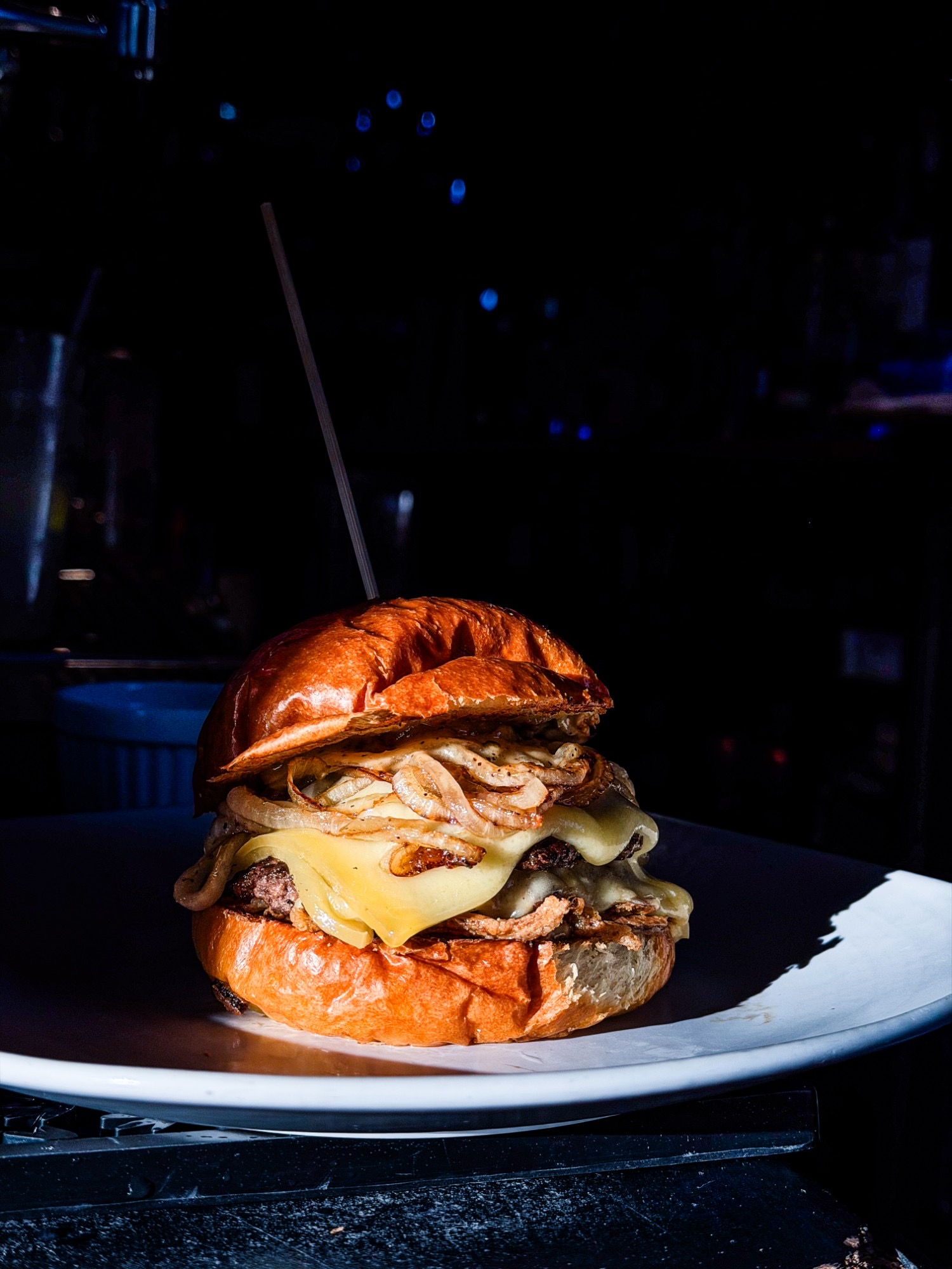 The Gruyere Affair burger, two patties with melted gruyere and golden onions on a brioche bun